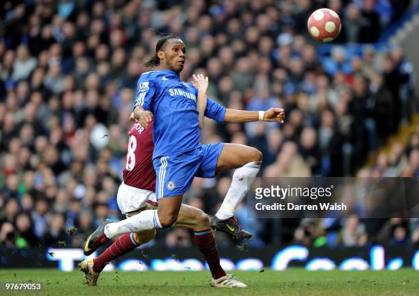 Didier Drogba of Chelsea is pulled down in the area by Jonathan Spector of West Ham, but play is waved on by the Referee Mark Clattenburg during the...