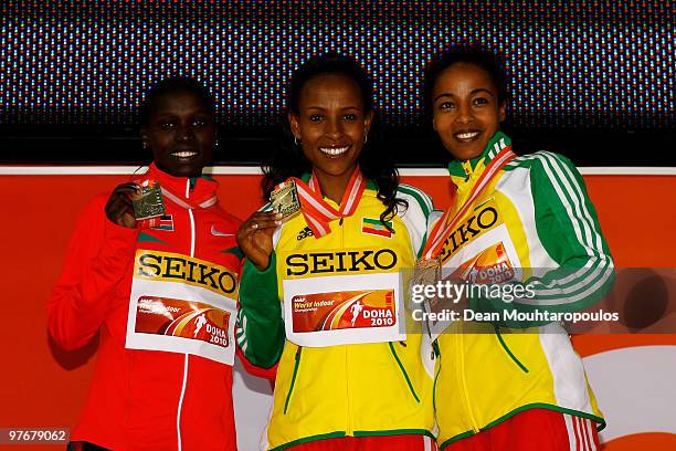 Meseret Defar of Ethiopia celebrates the silver medal, Vivian Cheruiyot of Kenya the gold medal and Sentayehu Ejigu of Ethiopia the bronze medal...