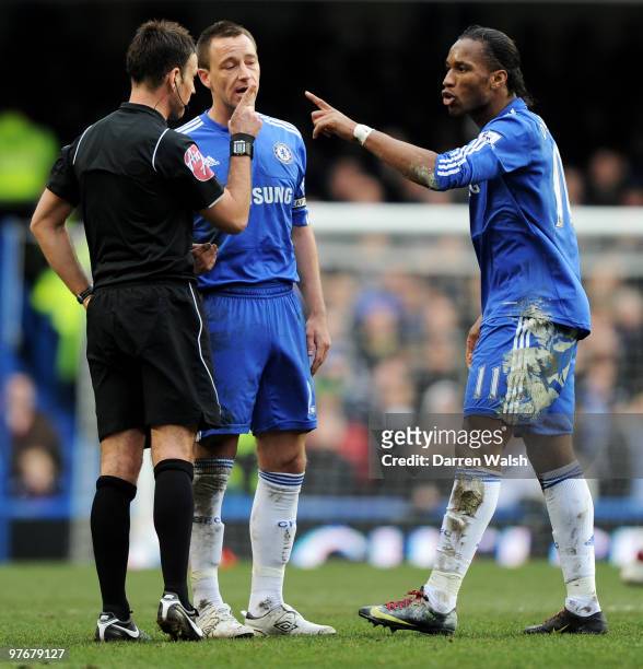Didier Drogba of Chelsea argues with Referee Mark Clattenburg as his captain John Terry attempts to remove him from the situation during the Barclays...