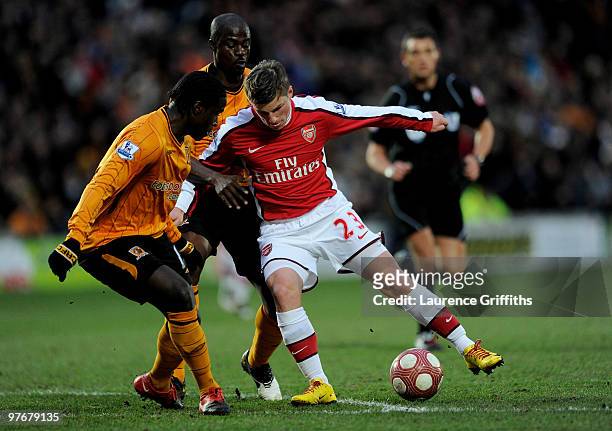 Andrey Arshavin of Arsenal turns Bernard Mendy and George Boateng of Hull City to score the first goal during the Barclays Premier League match...