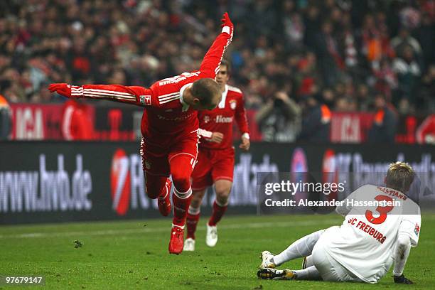 Arjen Robben of Muenchen battles for the ball with Felix Bastians of Freiburg during the Bundesliga match between FC Bayern Muenchen and SC Freiburg...