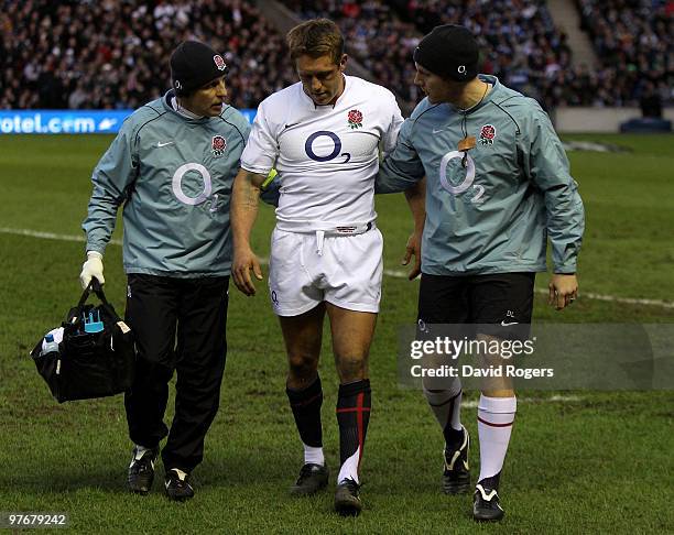 Jonny Wilkinson of England is helped from the pitch with an injury during the RBS Six Nations Championship match between Scotland and England at...