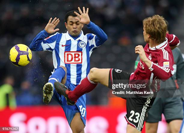 Raffael of Berlin is challenged by Andreas Ottl of Nuernberg during the Bundesliga match between Hertha BSC Berlin and 1.FC Nuernberg at Olympic...