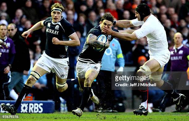 Max Evans of Scotland is tackled by Steven Borthwick of England during the RBS Six Nations match between Scotland and England at Murrayfield Stadium...
