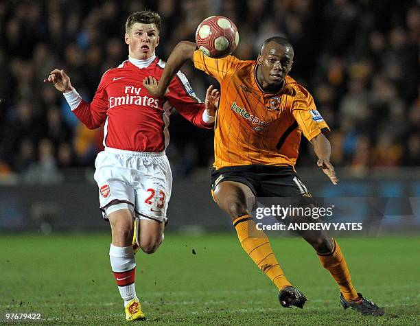 Hull City's French defender Steven Mouyokolo vies with Arsenal's Russian midfielder Andrey Arshavin during the English Premier League football match...