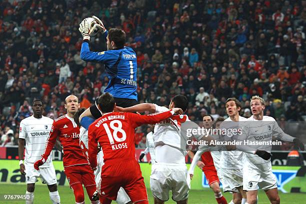 Simon Pouplin, goalkeeper of Freiburg safes the ball during the Bundesliga match between FC Bayern Muenchen and SC Freiburg at Allianz Arena on March...