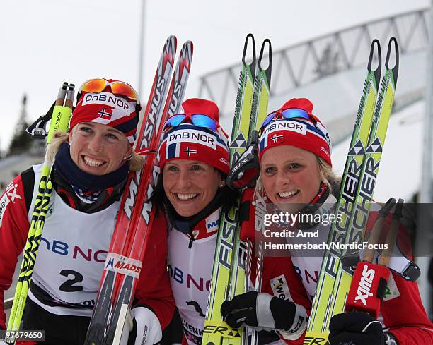 Second placed Kristin Steira Stoermer of Norway, first placed Marit Bjoergen of Norway and third placed Therese Johaug of Norway celebrate after the...