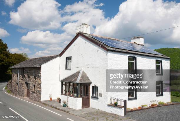 Kilowatt solar voltaic panel array on an old house in Blawith, South Cumbria, UK.
