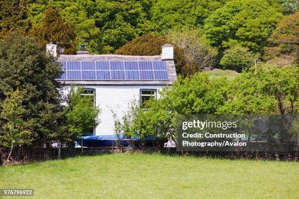 Kilowatt solar voltaic panel array on an old house in Blawith, South Cumbria, UK.