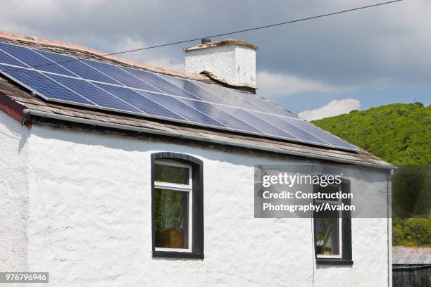 Kilowatt solar voltaic panel array on an old house in Blawith, South Cumbria, UK.