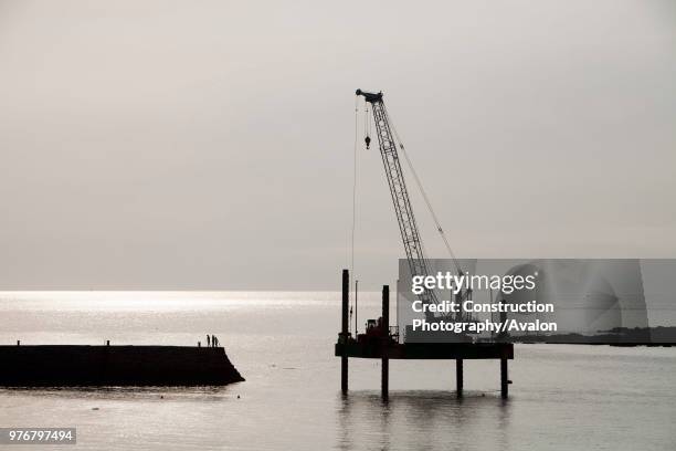 Crane on a platform off Sennen cove Harbour in Cornwall, UK.