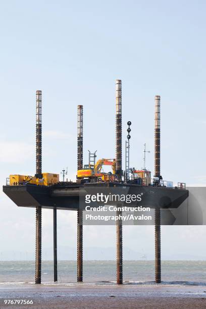 Jack up barge working on the foreshore of the Solway Firth near Workington, installing the power cable that will carry the electricity from the new...