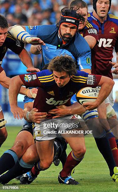 Highlanders wing James Paterson is tackled by Bulls captian Victor Matfield during the Super14 match at Loftus Versfeld Stadium in Pretoria, on March...