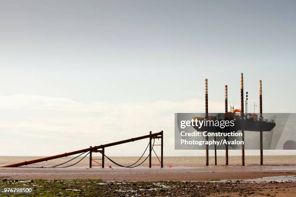 Jack up barge working on the foreshore of the Solway Firth near Workington, installing the power cable that will carry the electricity from the new...