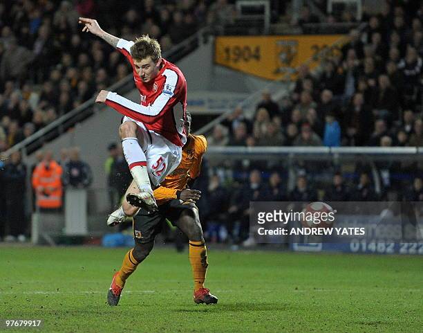 Arsenal's Danish forward Nicklas Bendtner scores the late second goal in the English Premier League football match between Hull City and Arsenal at...