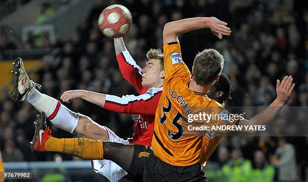 Arsenal's Danish forward Nicklas Bendtner vies with Hull City's Scottish defender Liam Cooper during the English Premier League football match...