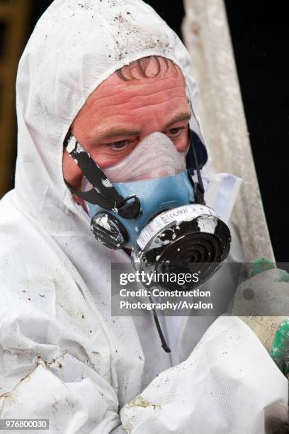 Specialist asbestos removal company removing asbestos from a shed roof of a house in Ambleside, Cumbria, UK.