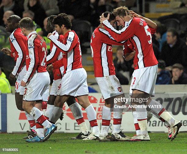 Arsenal's Danish forward Nicklas Bendtner celebrates with team-mates after scoring the winning goal in the 2-1 victory in the English Premier League...