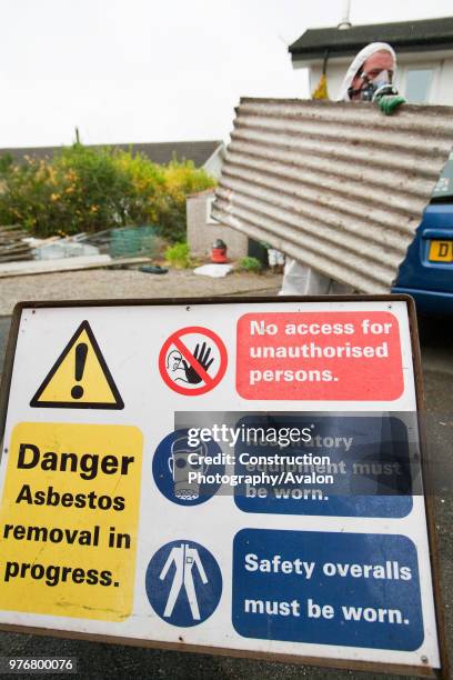 Specialist asbestos removal company removing asbestos from a shed roof of a house in Ambleside, Cumbria, UK.