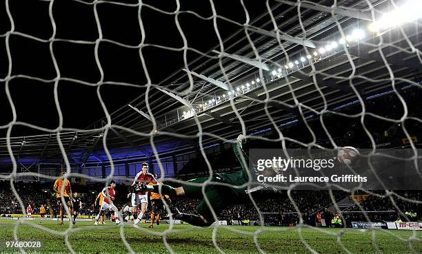 Nicklas Bendtner of Arsenal scores the 2nd goal during the Barclays Premier League match between Hull City and Arsenal at KC Stadium on March 13,...