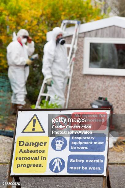 Specialist asbestos removal company removing asbestos from a shed roof of a house in Ambleside, Cumbria, UK.