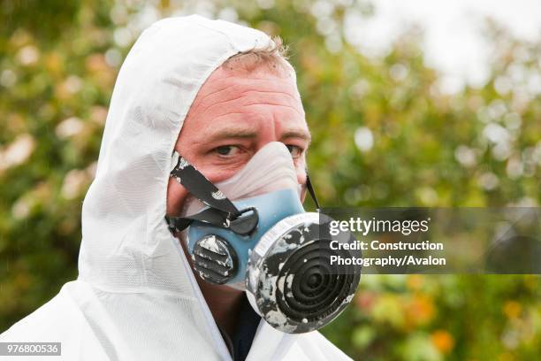 Specialist asbestos removal company removing asbestos from a shed roof of a house in Ambleside, Cumbria, UK.