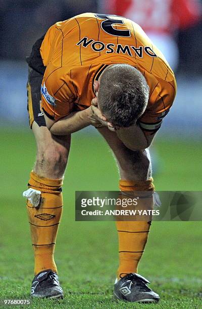 Hull City's English defender Andy Dawson reacts after Arsenal's injury time winning goal in the English Premier League football match between Hull...