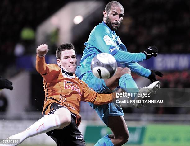 Lorient's forward Kevin Gameiro fights for the ball with Len's defender Eric Chelle on March 13, 2010 during the French L1 football match Lorient vs....