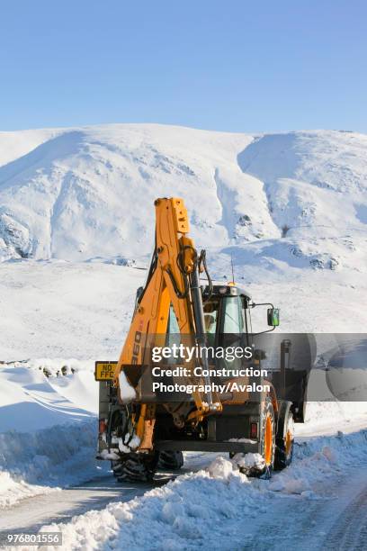 Charlie Middleton, an employee of cumbria vounty council clears snow from the blocked Kirkstone Pass, the highest mountain pass in the Lake District...