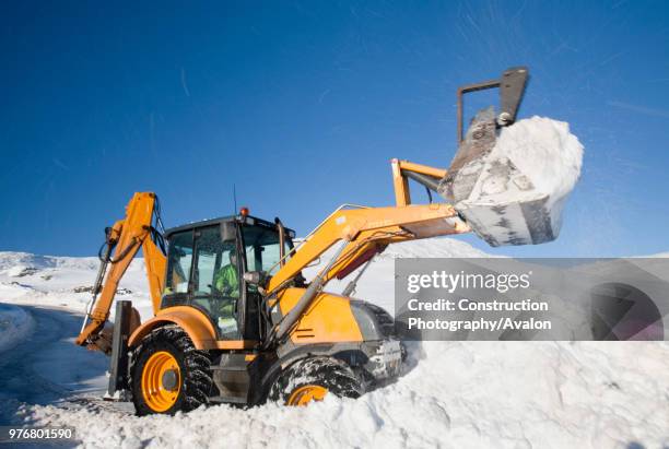 Charlie Middleton, an employee of cumbria vounty council clears snow from the blocked Kirkstone Pass, the highest mountain pass in the Lake District...