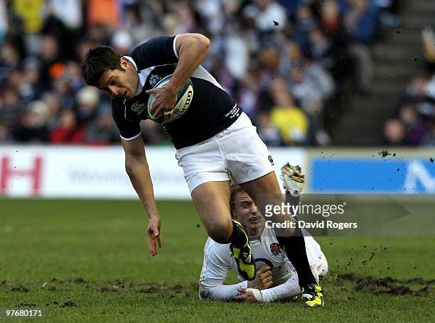 Hugo Southwell of Scotland is tackled by Matthew Tait of England during the RBS Six Nations Championship match between Scotland and England at...