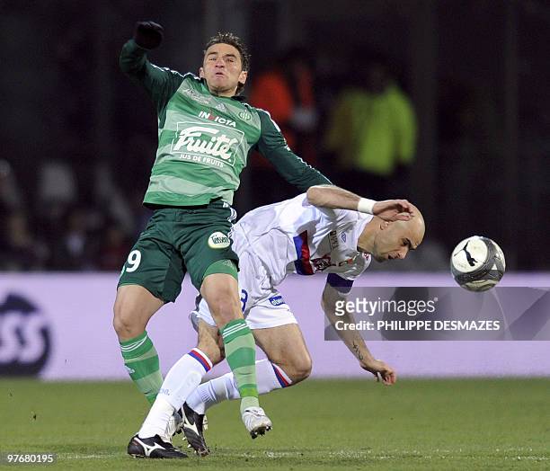 Lyon's Brazilian defender Cristiano Marques fights for the ball with Saint-Etienne's Argentinian forward Ruben Bergessio during the French L1...