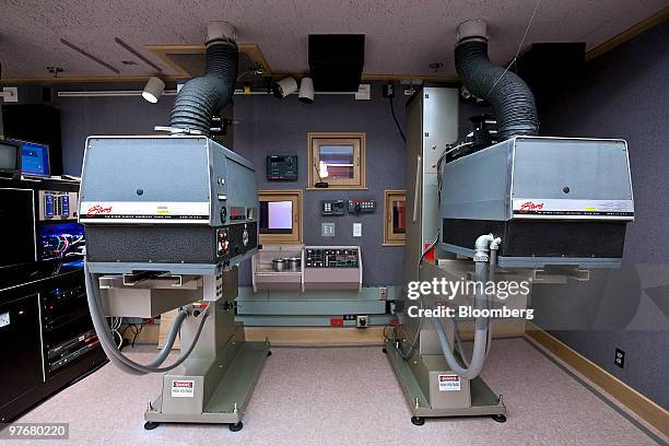 Film projectors sit behind the screening room at the headquarters of Dolby Laboratories Inc. In San Francisco, U.S., on Friday, March 12, 2010. U.S....