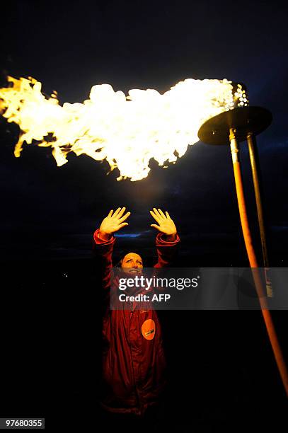 Volunteer looks on after a beacon is lit on Hadrian's Wall at Steel Rigg Northumberland on March 13, 2010. Hadrian's Wall is being lit from end to...