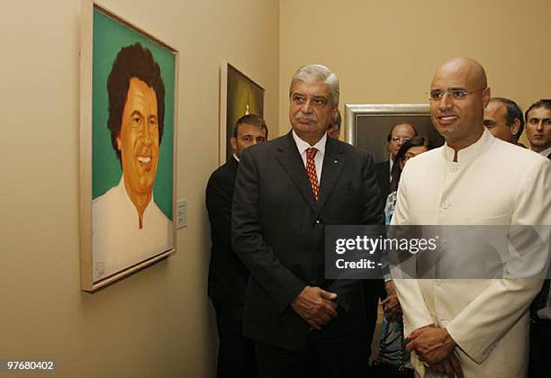 Libyan architect and artist Seif al-Islam Kadhafi , son of Libya's leader Moammer Kadhafi, stands in front of a portrait of his father that he...