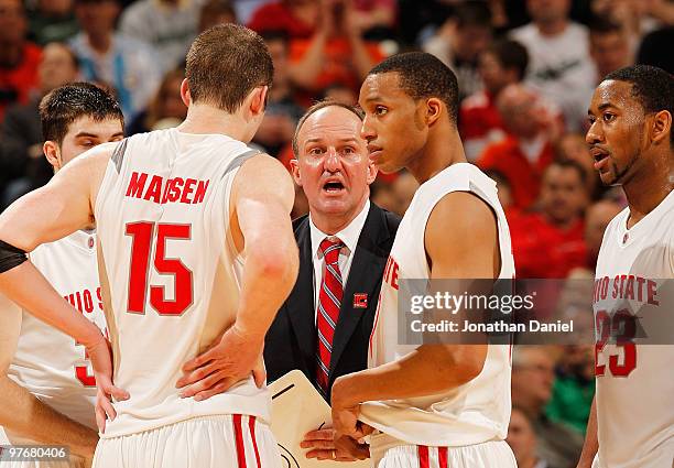 Head coach Thad Matta of the Ohio State Buckeyes talks with his team during a timeout in their game against the Illinois Fighting Illini in the...