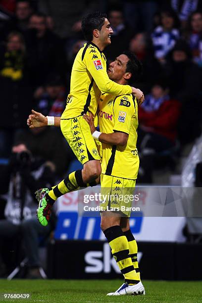 Lucas Barrios of Dortmund celebrates after scoring his teams third goal with team mate Nuri Sahin during the Bundesliga match between VfL Bochum and...