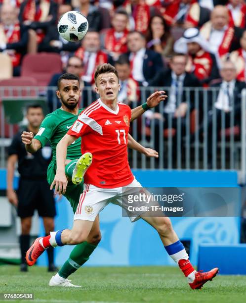 Mohammed Alburayk of Saudi Arabia and Aleksandr Golovin of Russia battle for the ball during the 2018 FIFA World Cup Russia group A match between...