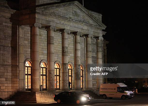 Police truck sits in front of the Waterford Court House as one of four people arrested by Irish police arrives at the Waterford court house in...