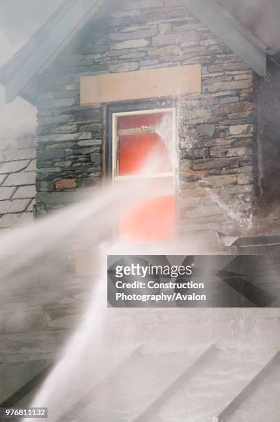 Fire being tackled by firemen in Ambleside UK.