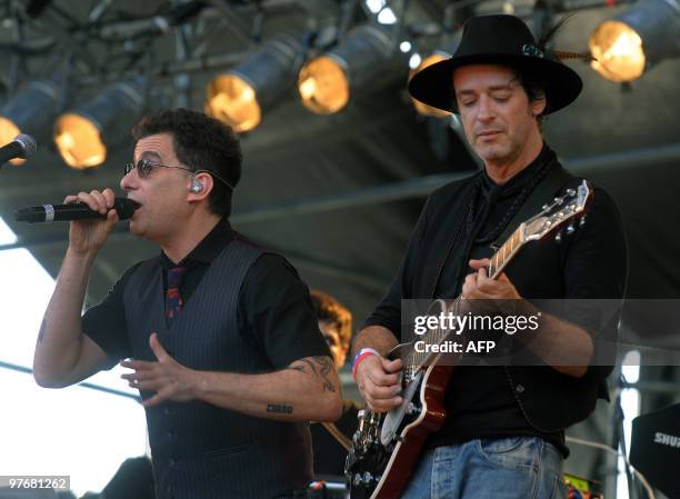 Argentinian musicians Gustavo Cerati and Andres Calamaro perform during the "Argentina embraces Chile" solidarity concert in Palermo park, Buenos...