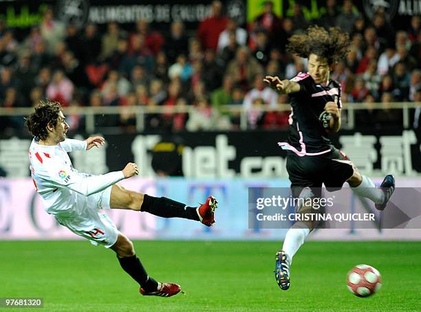 Sevilla's French defender Julien Escude vies with Deportivo Coruna's Mexican midfielder Andres Guardado during a Spanish league football match at...