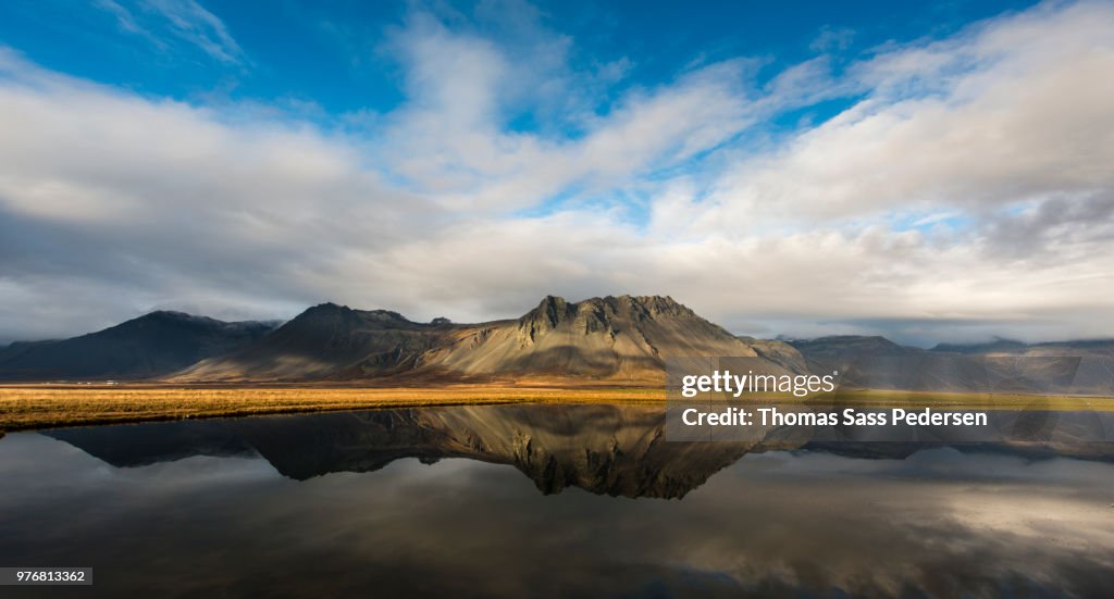 Mountains reflecting in calm water, Iceland