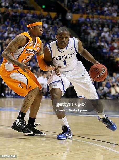 Darius Miller of the Kentucky Wildcats drives against Bobby Maze of the Tennessee Volunteers during the semirfinals of the SEC Men's Basketball...