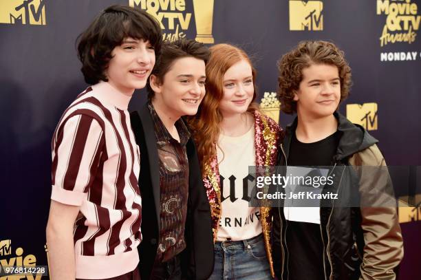 Actors Finn Wolfhard, Noah Schnapp, Sadie Sink, and Gaten Matarazzo attend the 2018 MTV Movie And TV Awards at Barker Hangar on June 16, 2018 in...