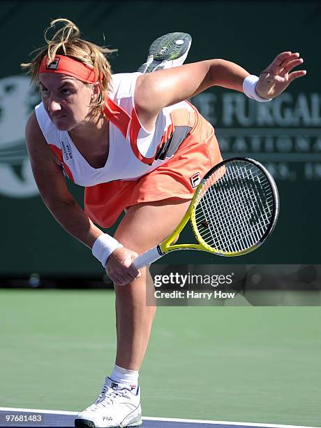 Svetlana Kuznetsova of Russia serves during her match against Carla Suarez Navarro of Spain during the BNP Paribas Open at the Indian Wells Tennis...