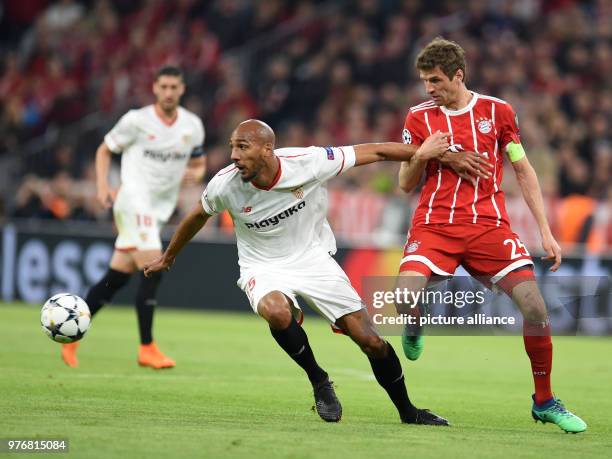 Bayern munichs thomas mueller and sevillas steven nzonzi battle for the ball during the uefa Bayern munichs thomas mueller and sevillas steven nzonzi battle for the ball during the uefa