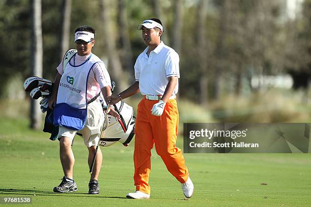 Yuta Ikeda of Japan walk up the 12th hole during round three of the 2010 WGC-CA Championship at the TPC Blue Monster at Doral on March 13, 2010 in...