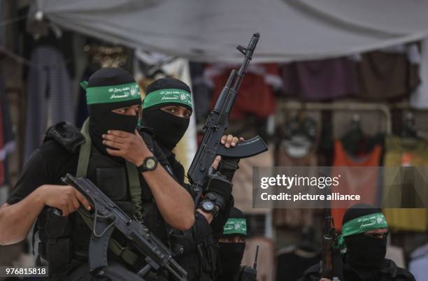 Dpatop - Masked militants of Izz ad-Din al-Qassam Brigades, the armed wing of the Palestinian Hamas Islamist movement, attend the funeral of Hamas...