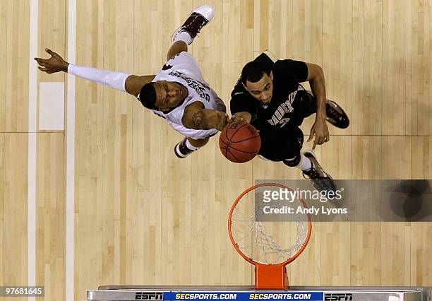 Andre Walker of the Vanderbilt Commodores attempts a shot against Romero Osby of the Mississippi State Bulldogs the Vanderbilt Commodores during the...